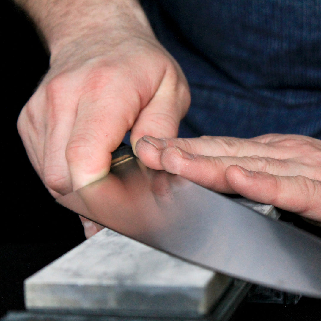 Hand Sharpening Knife On A Stone