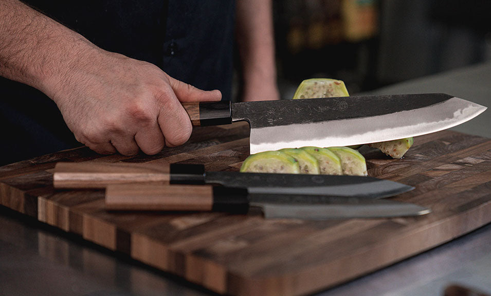 Home Chef Slicing Fruit On Cutting Board