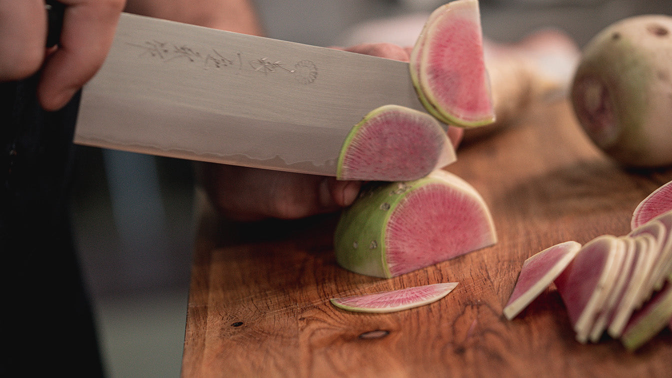 Home Chef Slicing Vegetables On Cutting Board